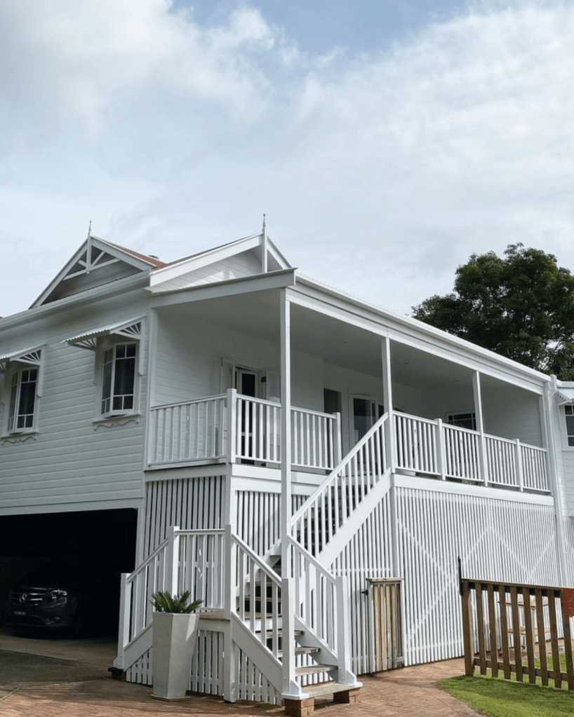 freshly painted white Queenslander house