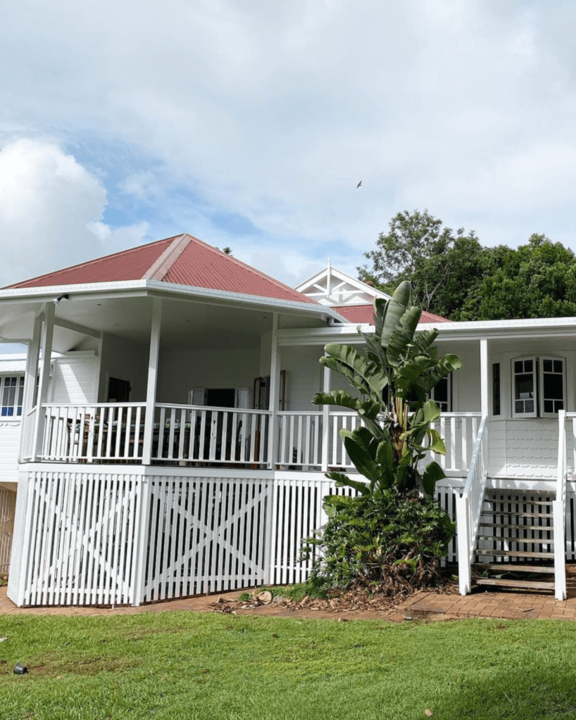 freshly painted white Queenslander house